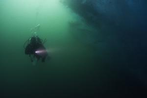 Francisca diving along the edge of an iceberg